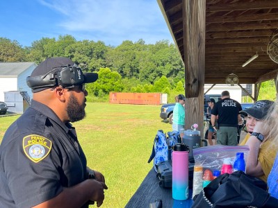 A man in a police uniform talking to a woman.