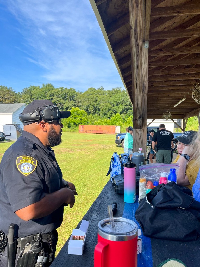 A man in a police uniform talking to a woman.