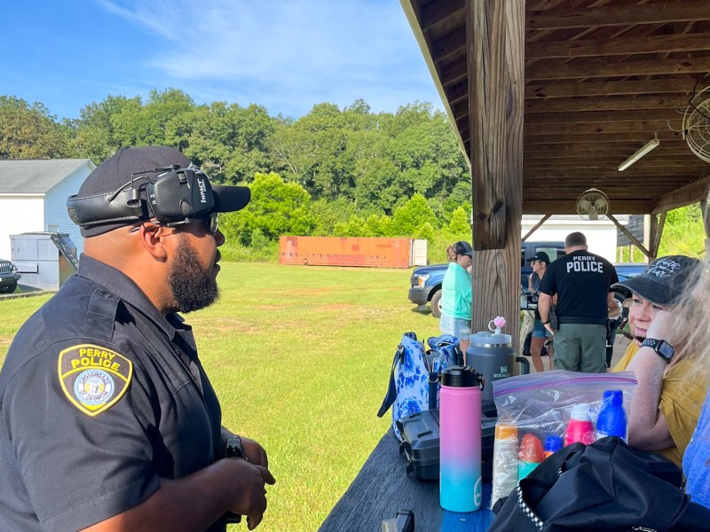 A man in a police uniform talking to a woman.