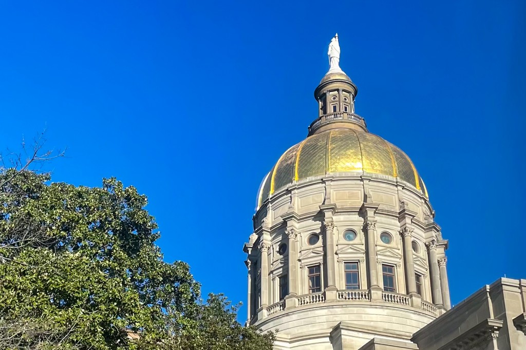A tall building with a golden dome.