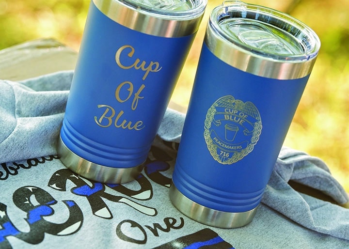 Two blue metal cups with Cup of Blue on them.