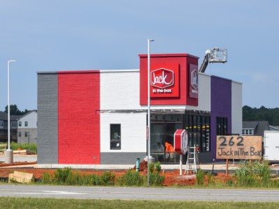 A red and purple building under construction.