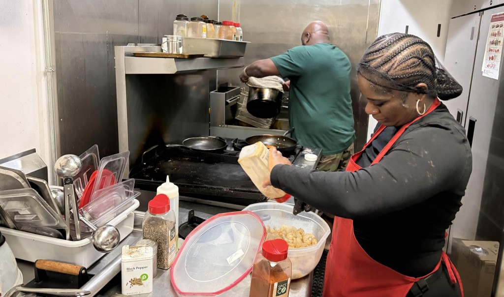 Taste Good Restaurant owner and his girlfriend are shown working in the kitchen of the takeout spot.