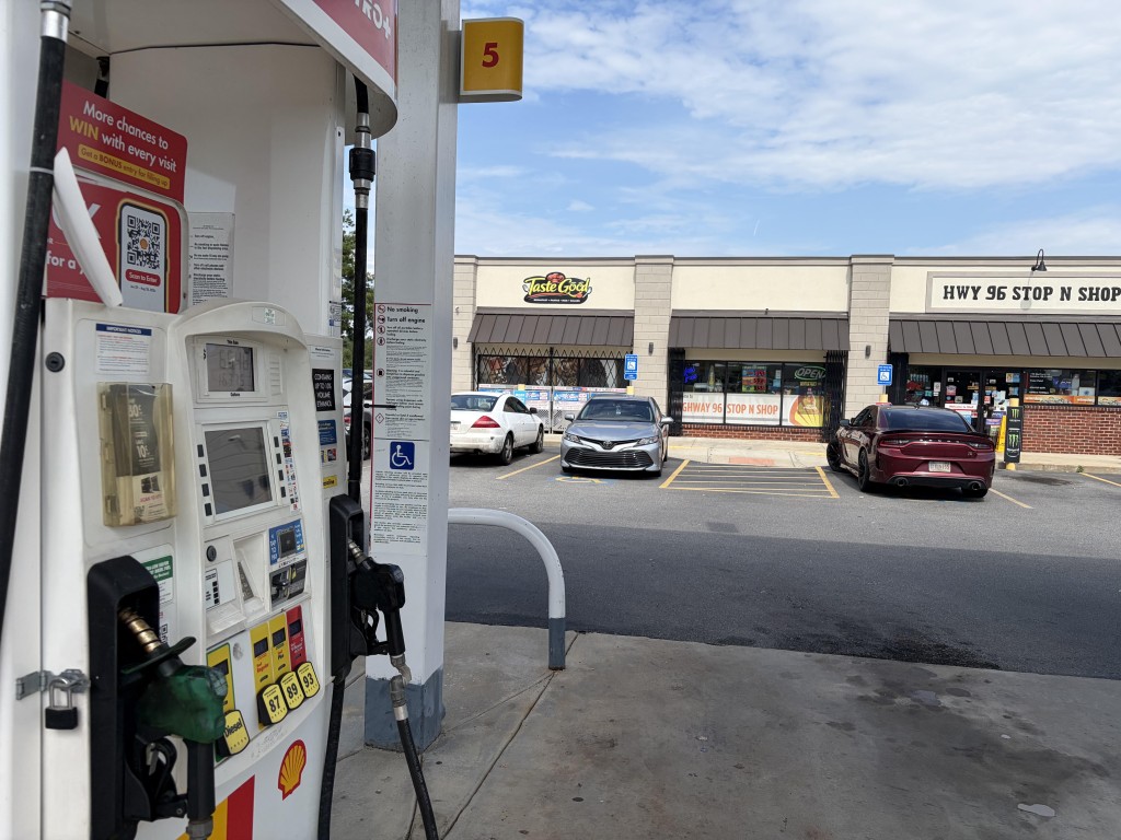 The Taste Good Restaurant sign can be seen on Hwy 96 Stop N Shop convenience store in the background with Shell gas pump in the foreground.
