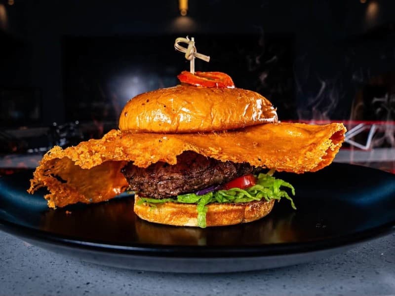 A juicy chuck, brisket, and short rib blend is topped with creamy cherry pepper cream cheese and a crispy fried cheddar skirt for the perfect combination of melty, crunchy, and spicy. Finished with all the classic burger fixings on a soft Martin’s potato bun and garnished with cherry peppers, this flavor bomb is bold, cheesy,