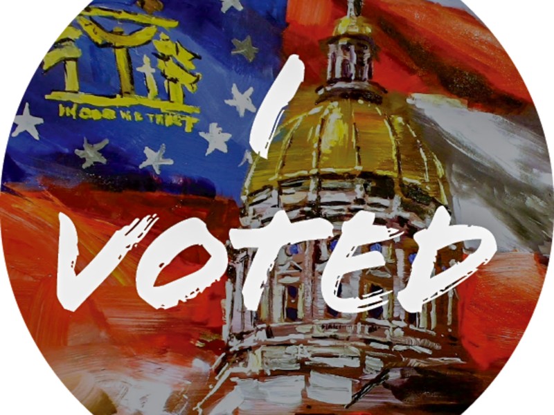 A circular sticker with the Georgia capital. The state's red, white, and blue flag is in the background. On top is "I Voted" in white letters.